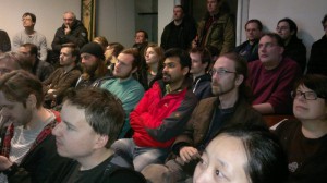 A packed room listens to the talks at the ownCloud 5 release event.